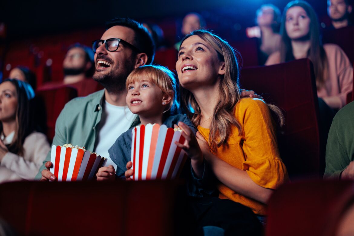 Family watching movie in theatre