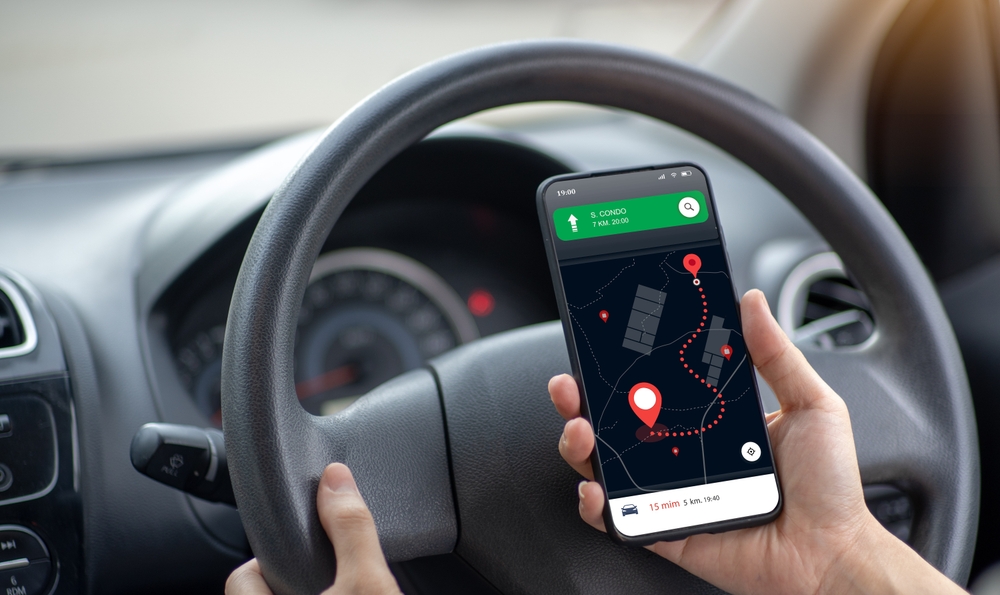 Use the mobile phone in google map search mode, inside the black car. Turn on the online location navigator to the destination or near by places.