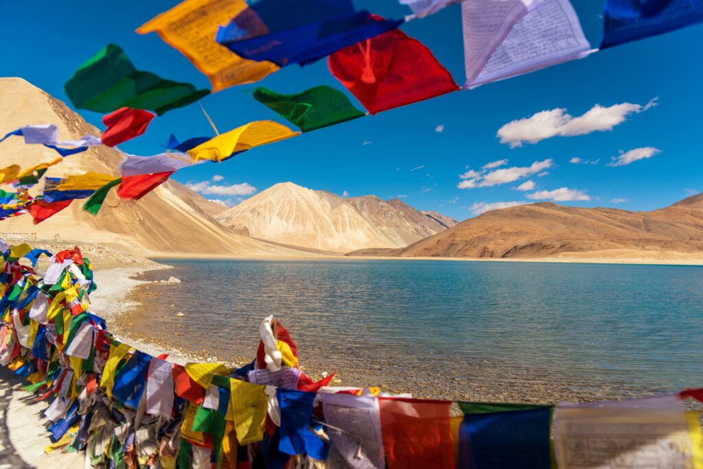 Mountains and Pangong tso (Lake). It is huge and highest lake in Ladakh and blue sky in background, it extends from India to Tibet. Leh, Ladakh, Jammu and Kashmir, India