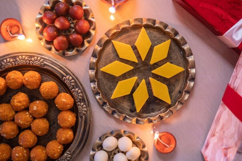 Diwali festival sweets with Diya lamp and Gift box on the table
