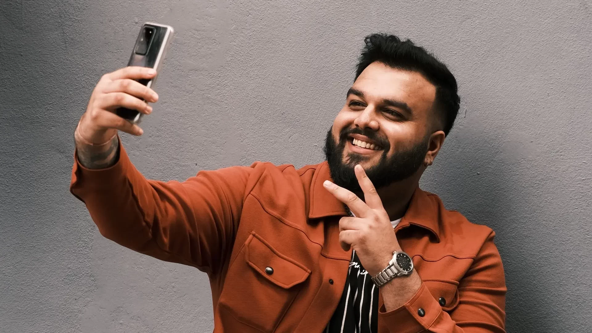 Happy young man taking selfie from his smartphone