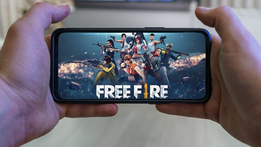 Playing Garena Free Fire mobile game. Point of view gaming on smartphone.