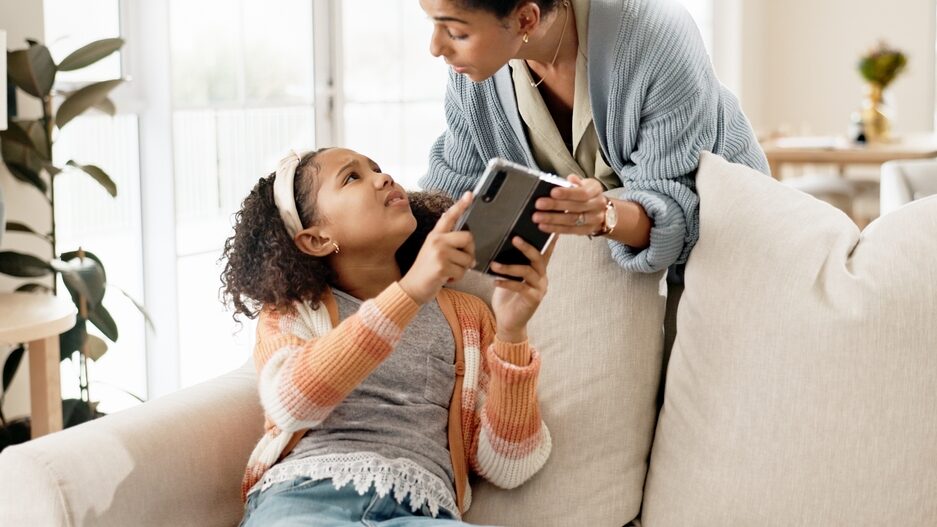 Phone, mother and home with discipline for child for limit of screen time for content exposure and cognitive development. Mom, girl and control or authority of cellphone for boundaries and parenting